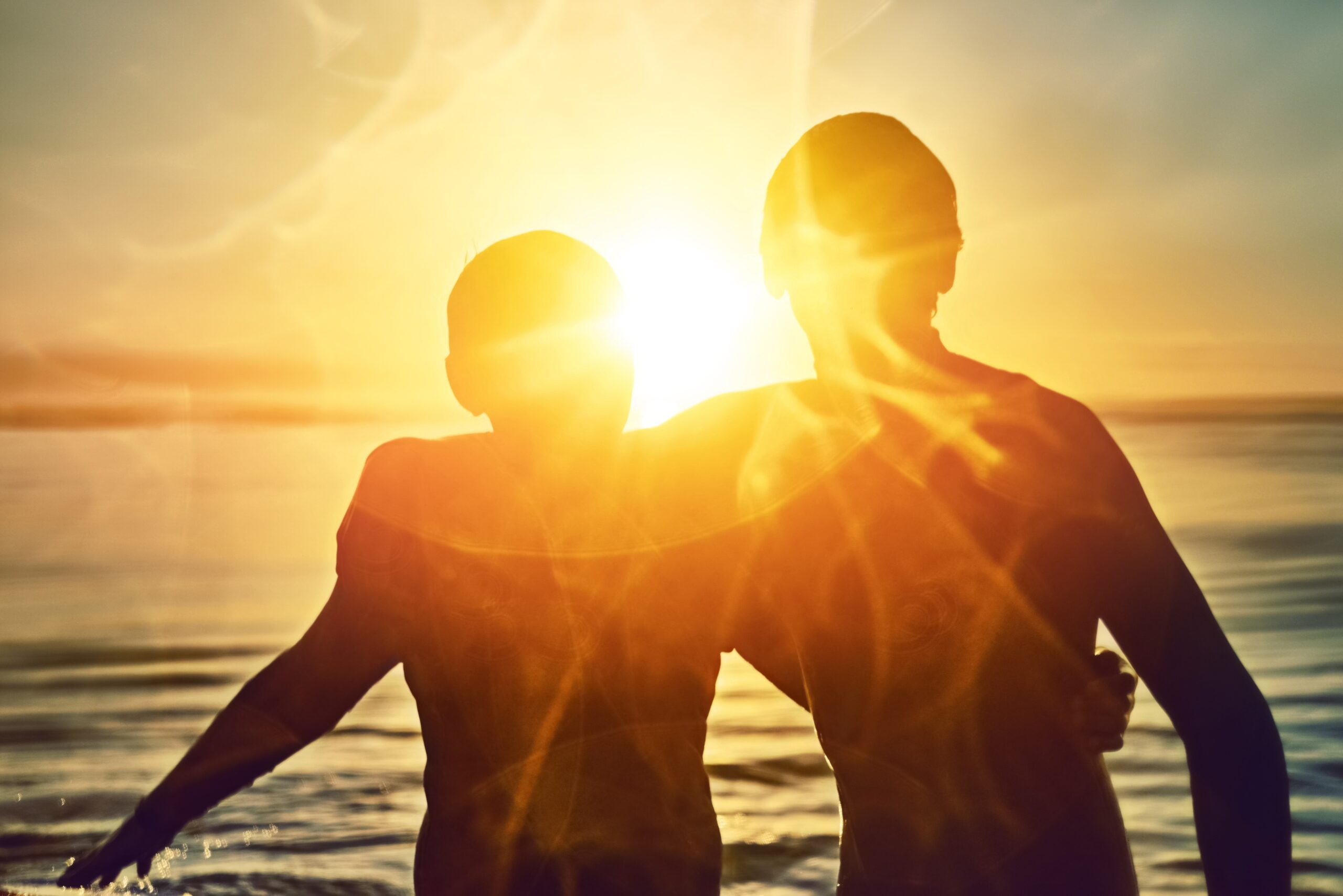 Silhouette,,Sunshine,Or,Friends,Hug,At,Sea,For,Fitness,Training, Silhouetted soldiers saluting at sunset with a large American flag blended into the sky background.